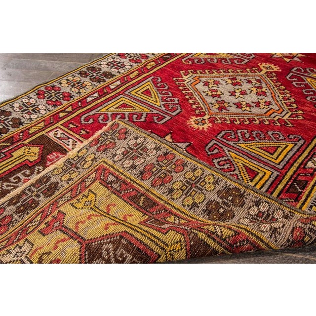 This captivating vintage Persian Kilim from 1955 is a radiant example of mid-century tribal artistry, woven entirely by...