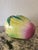 A large Chinese altar fruit modeled as a ripening peach, glowing chartreuse green with a soft raspberry blush at the tip....