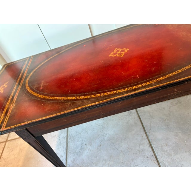 English Regency Style Leather Top Drop Leaf Table With Tooled Gilt Decoration This elegant leather top drop leaf table was...