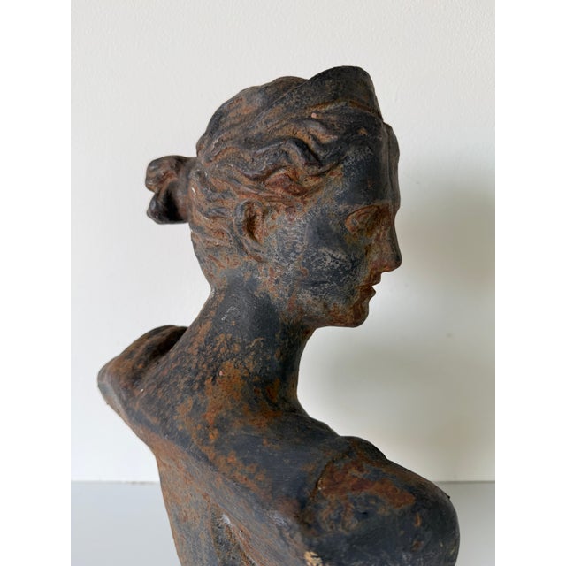 Classic antique cast iron bust depicting Diana, the Roman goddess of the hunt, captured in a graceful side profile with...