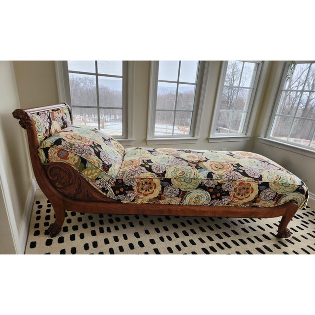 Victorian Eastlake fainting couch. Intricately carved mahogany wood with classic lions' head motif. Recently retied and...
