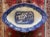 Antique Blue Willow footed oval serving dish featuring a blue transfer chinoiserie pattern on the interior. Made by...