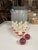 An antique hand painted table top bowling game set with nine white and red painted wooden pins and two red wooden balls....