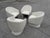 Set of four Noah Armchairs by Lievo, featuring sculptural curved silhouettes upholstered in textured cream bouclé. Each...