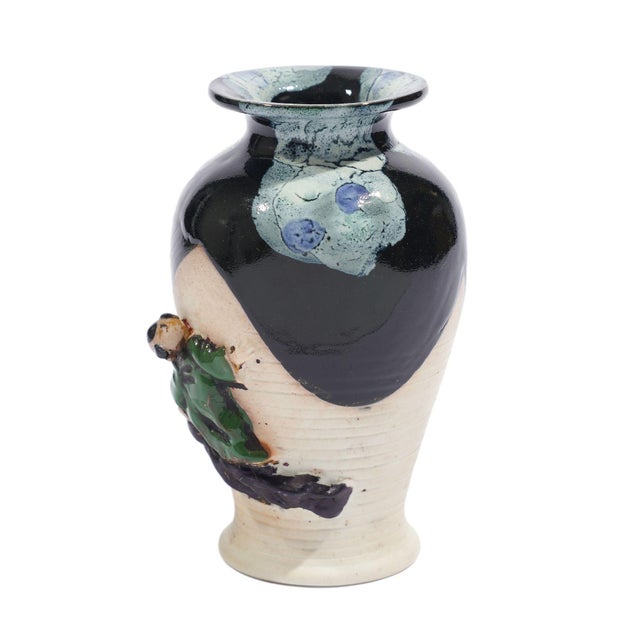 Sumida Gawa hand thrown baluster form vase with partial glazing and an applied figure of a small child climbing the side...