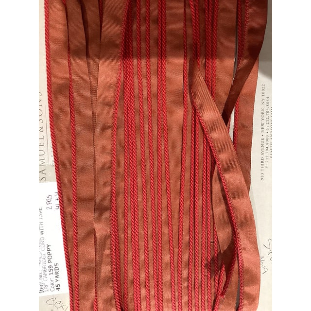 Poppy fabric with sewn red trim. about 6-8 yards available Measures 1/8 of an inch