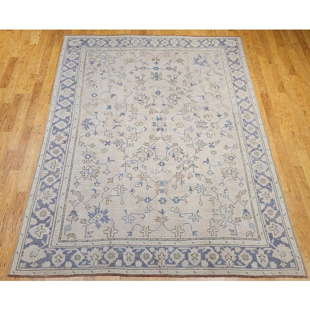 Discover the serene elegance and enduring beauty of this magnificent Mid-20th Century Vintage Turkish Oushak Room Size...