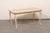 A French Louis XV style carved wood coffee table from the mid 20th century. This mid-century table from France is...
