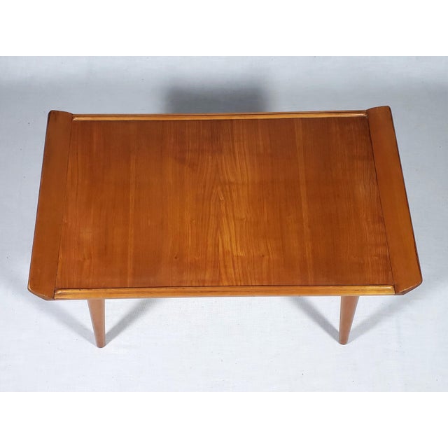 This coffee table is a beautiful solid piece that has lovely wood grain, and great patina. The design is unusual and I...