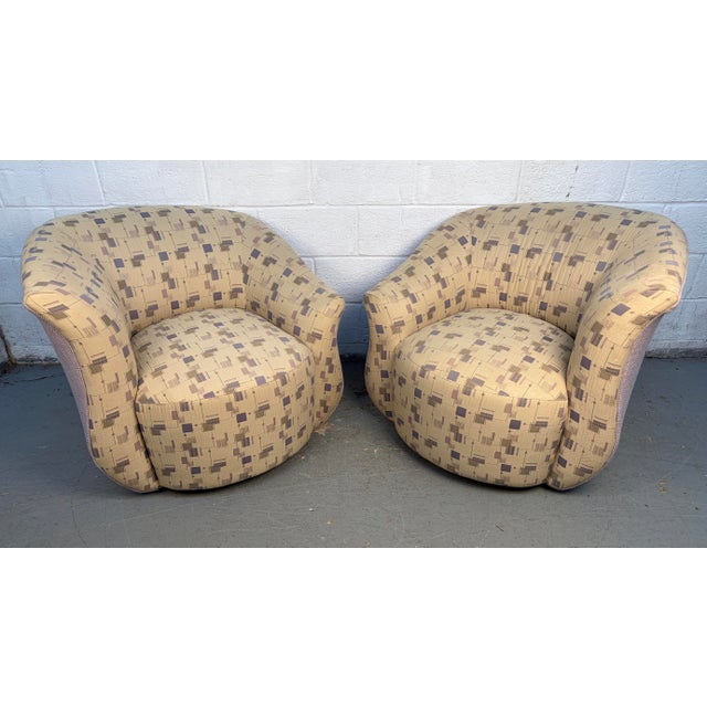 A striking pair of oversized swivel lounge chairs Attributed to Weiman, designed for exceptional comfort and bold...