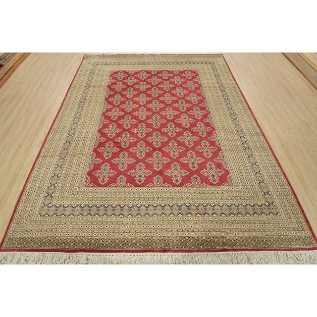 A tribal Bokhara Jaldar rug hand-knotted with an all-wool pile on a cotton foundation. This finely woven oriental rug...
