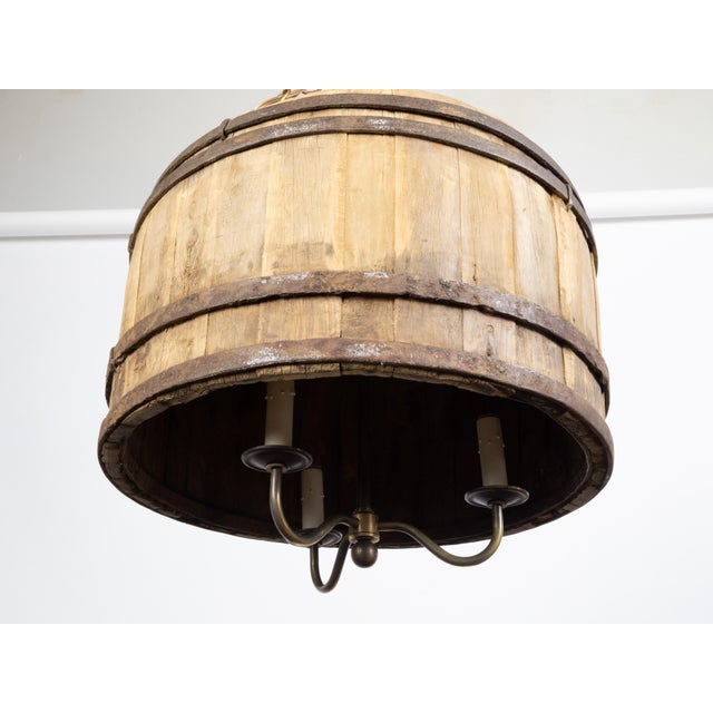 An English vintage wooden barrel light fixture from the mid 20th century, with three arms. Created in England during the...