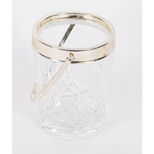 A superb pair of vintage silver-plate mounted cut glass ice buckets, mid 20th century in date. The cylinder-shaped...