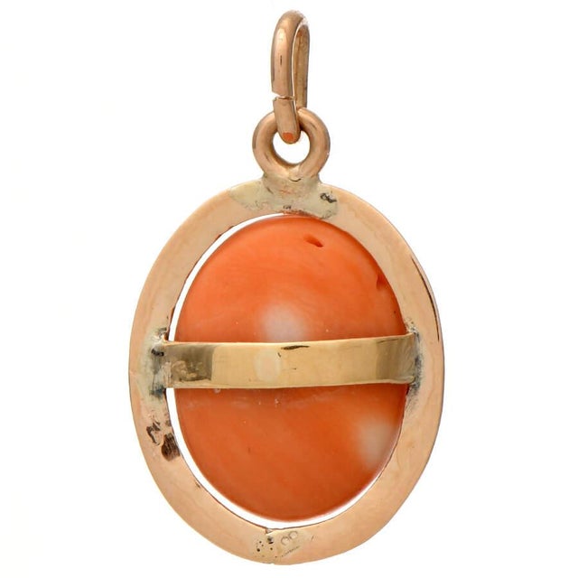 Warm and sensual, this striking coral bead pendant commands attention from across a room. Crafted of 14K yellow gold, the...