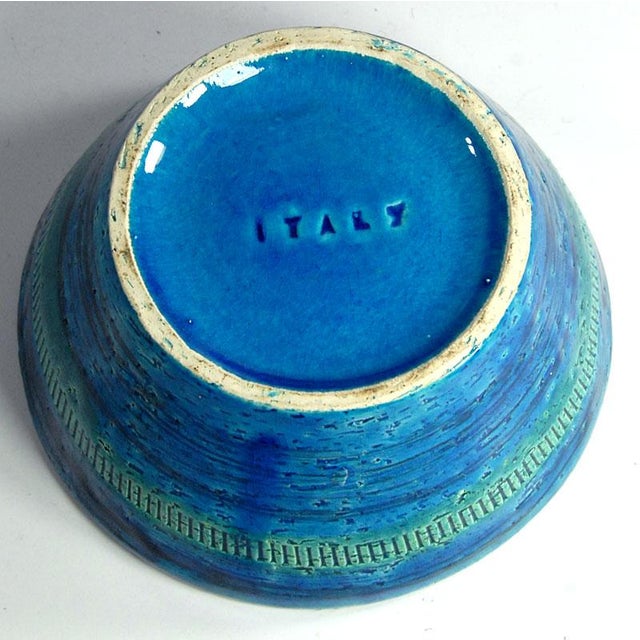 A large table vase made of ceramic decorated with sgraffito and glazed in colors known as Rimini Blue. The vase was...