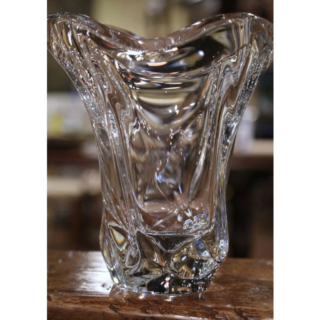 This elegant, hand blown crystal art vase was crafted in France, circa 1950. The large antique piece features a pulled...