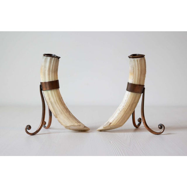 A pair of antique 19th century game animal horns mounted on metal stands. Created during the 19th century, each of this...
