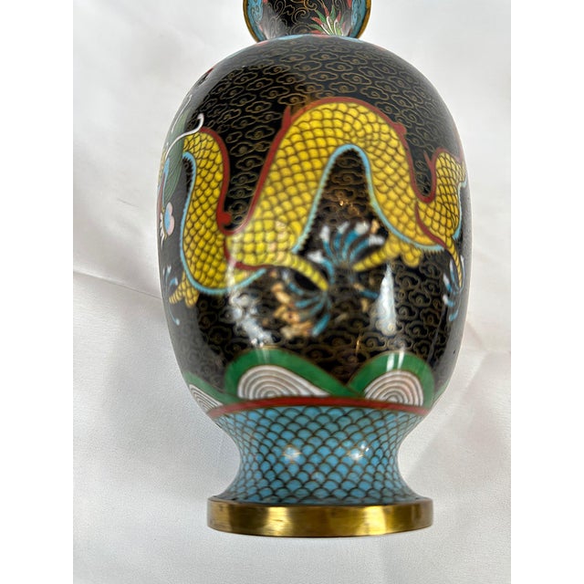 This is a beautiful set of three Chinese Qing Period Cloisonne Enamel Dragon Vases. This set features a deep ebony ground...