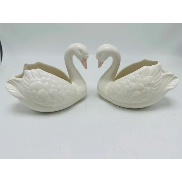 So graceful and pretty, this pair of swans is made by Fitz and Floyd! Ceramic in white with pink beaks