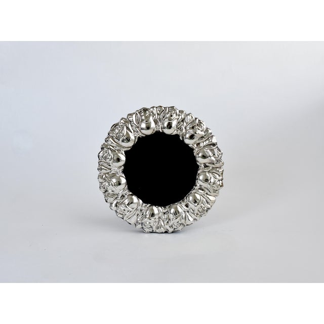 This exquisite vintage frame is crafted from 925 sterling silver and features a wide border of intricate repousse...