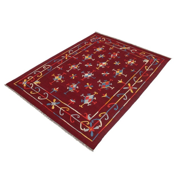 "Add a touch of elegance to your home with this casual chic hand woven Tribal Kilim wool rug. Constructed on a loom by...