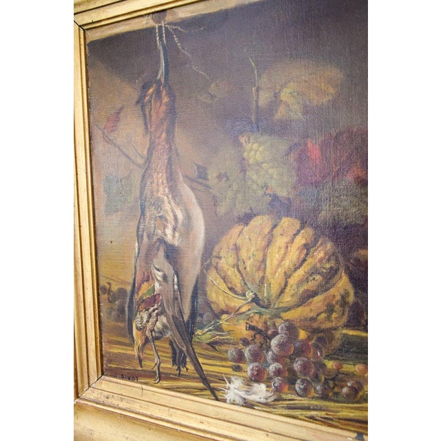 This still life oil painting depicts a pheasant, bunches of grapes, and a gourd. The painting is encased in a beautiful...