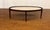 This is the Winthrop Oval Cocktail Table by Maitland - Smith. It features a stone top, dark walnut wood frame and metal...