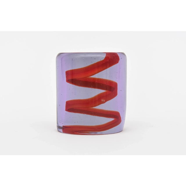 This interesting glass vintage paperweight that is light purple with red spiral zigzag design is a great desk accessory....