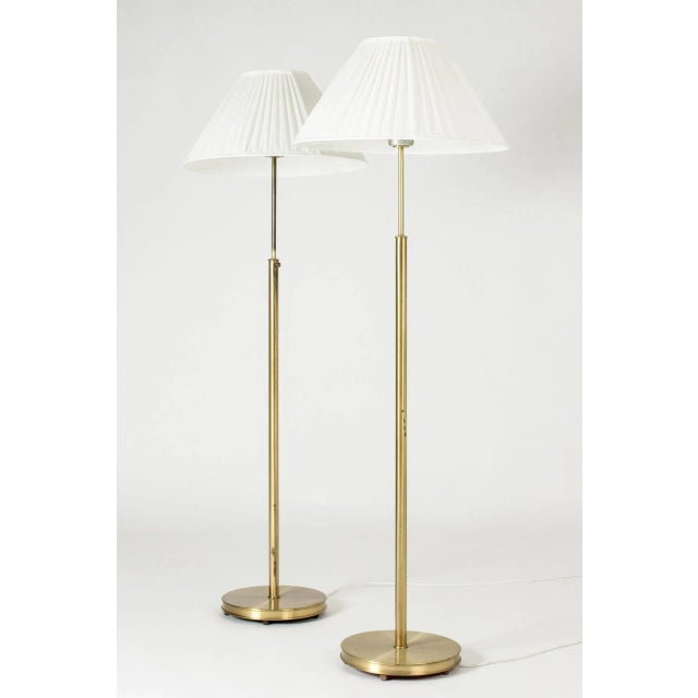 Pair of beautiful brass floor lamps by Josef Frank, made from brass with wide pleated shades. Decorative screws used for...