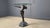 Vintage art deco style side bronze look table made of a resin base and a beveled glass clear top. Art deco style female...