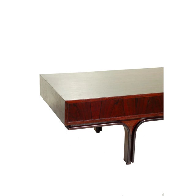 Gorgeous rosewood coffee table by Gianfranco Frattini for Cassina. Very good condition Minor defects to top This piece has...