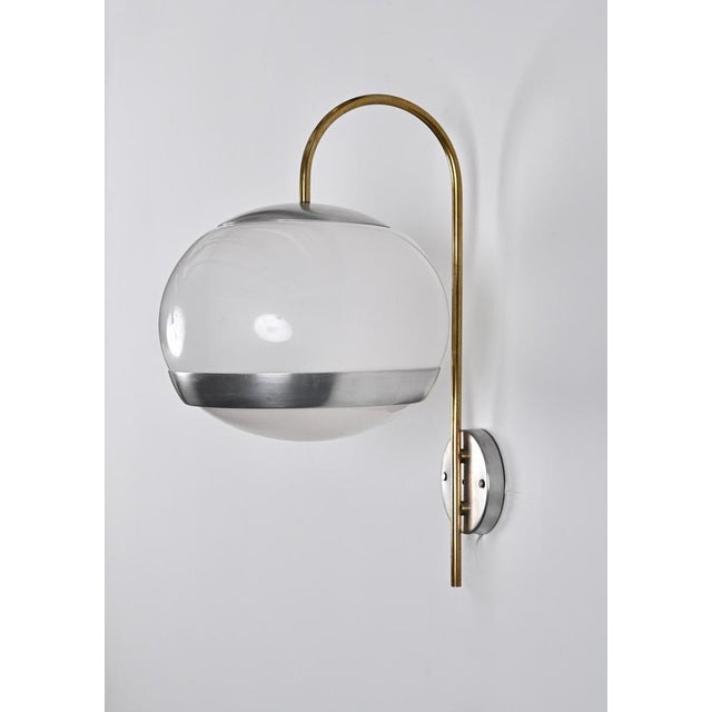 Wonderful pair of mid-century sconces in white white, aluminum and brass, produced by stilux in the 70s in italy. These...