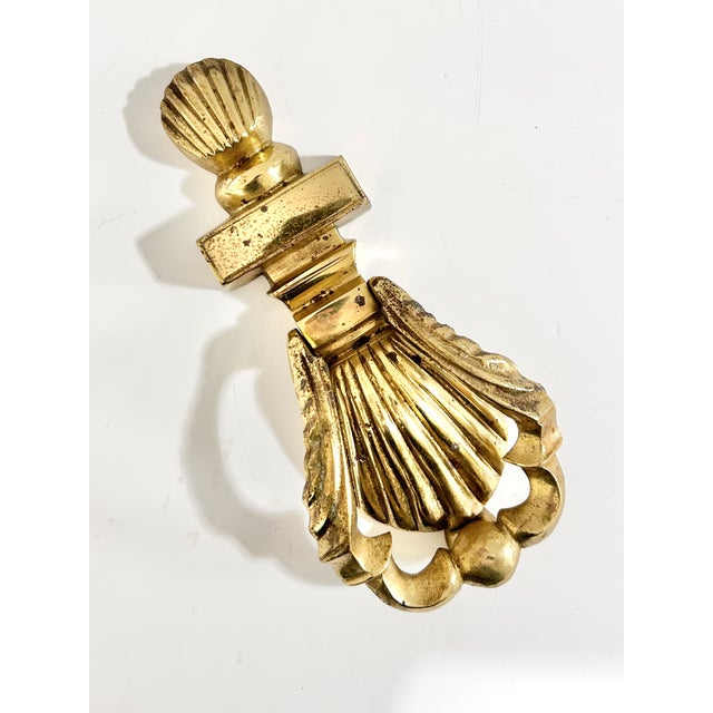 Crafted from substantial solid brass, this vintage door knocker features a classic shell motif inspired by Georgian and...
