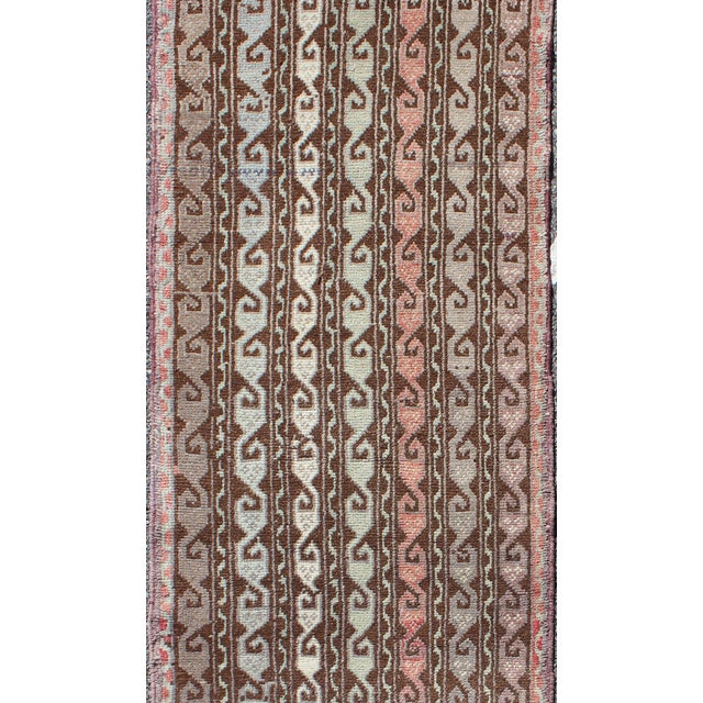 Measures: 2'1 x 6'10. Brown and pastel-colored vintage Turkish Oushak runner with vining geometrics. Keivan Woven Arts /...