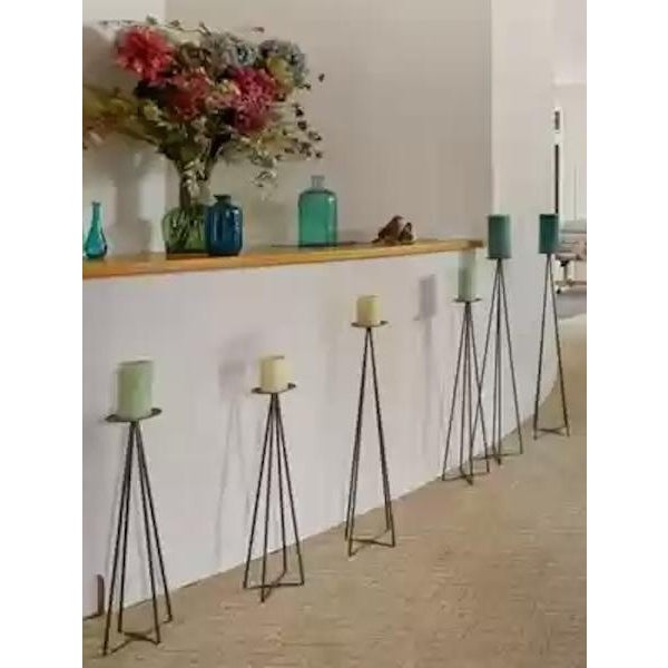 Used set of 6 metal floor tower candles that vary in size and are in great condition. They have minor cosmetic scratches...