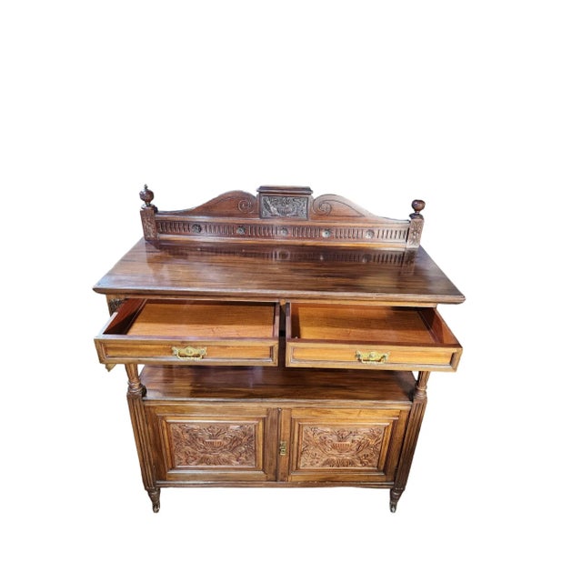 Beautiful early 1900s English mahogany carved double buffet on original castors, gallery back, and brass fittings. Double...