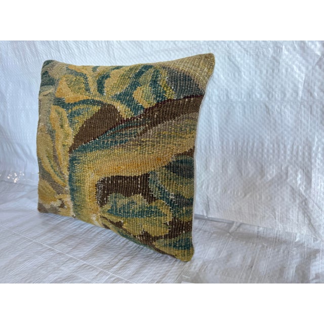 This decorative pillow is crafted from an authentic 17th-century Flemish tapestry fragment, featuring a richly textured...