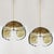 A pair of very nice pendant lights manufactured in mid century, circa 1970. Three smoke or amber tone murano glasses are...