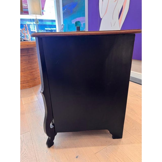 An early 18th century French Mazarine commode , three tiered with striking curved corner legs . Drawers with gentle double...