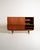 Danish teak tall sideboard from the 1960s, with sliding doors, three central drawers, and carved solid wood handles. The...