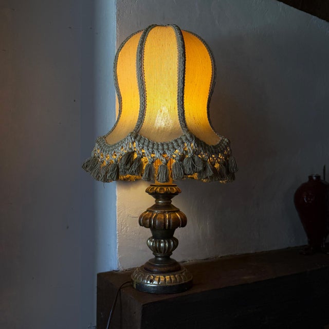 Classical vintage italian table lamp crafted from carved wood with a decorative gilt and painted finish the lamp is fitted...