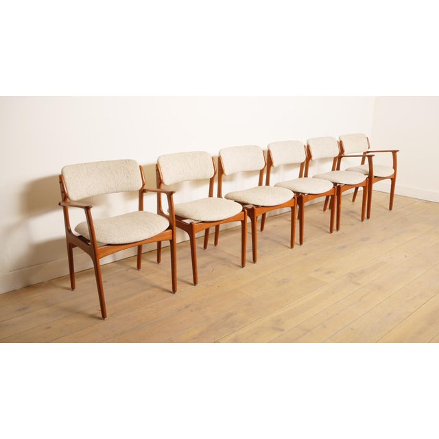 Set of 6 beautiful teak vintage dining chairs. These Danish chairs were designed by Erik Buch, model 49. 2 chairs have...