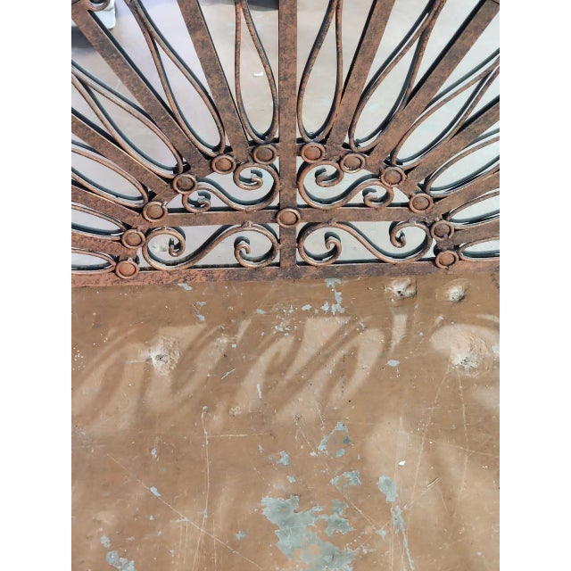 Beautiful continental wrought iron transom wall mirror in excellent condition. Finely hand wrought, heavy glass, later...