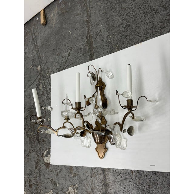Design Plus Gallery presents a Vintage Hollywood Regency Crystal Prism Five-Light Wall Sconce. This ornate electric...