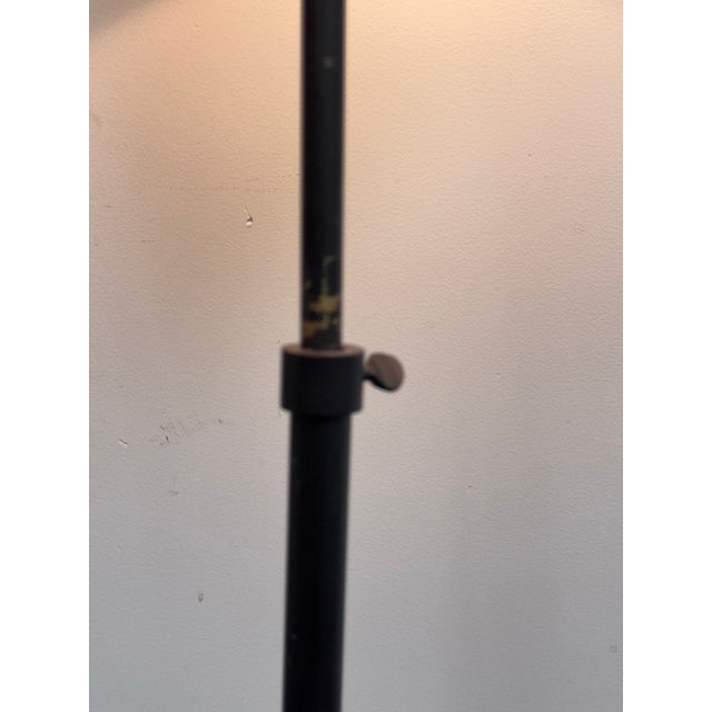 Design Plus Gallery presents an Adjustable Floor Lamp. A sleek and versatile floor lamp featuring a round metal base and...