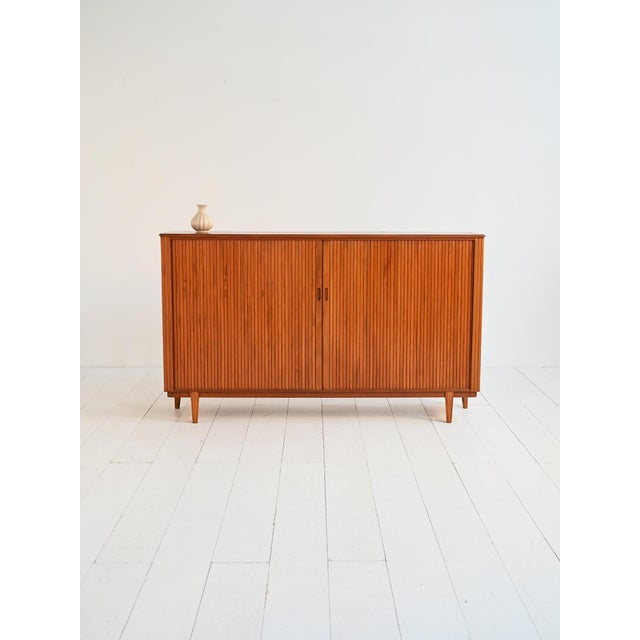 Teak highboard with tambour doors and adjustable internal shelves, Scandinavian production from the mid-20th century....
