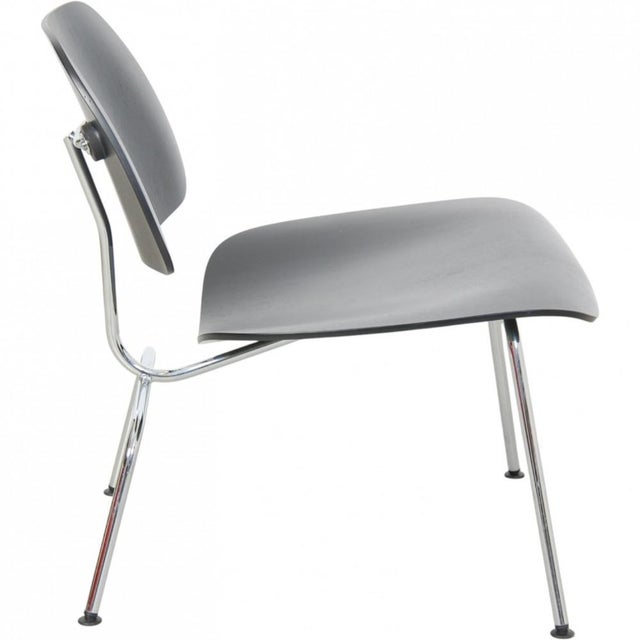 Charles Eames LCM chair with seat and backrests of black lacquered ash and a chrome frame. The chair appears in good...