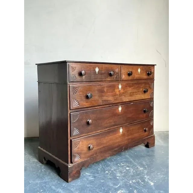 This handsome antique chest of drawers, likely dating from the mid-Victorian or late Georgian period, exhibits classic...