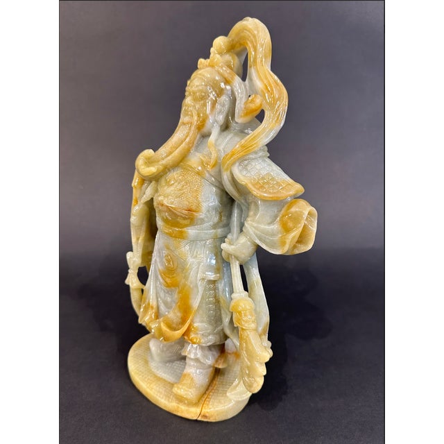 White & gold carved jade statue of famed Chinese general Guan Gong Yu. Traditionally depicted with his beard in one hand,...