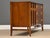 A mid century modern walnut three drawer dresser credenza with swooping walnut and brass arch details made by Broyhill...